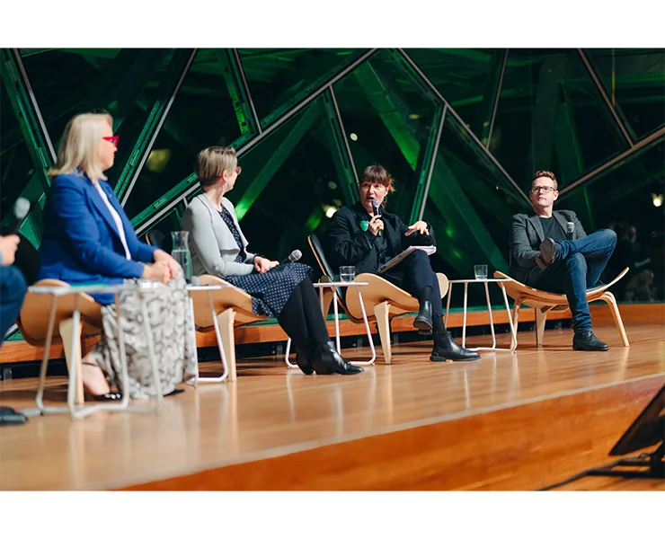 Four people on a stage participating in a panel discussion